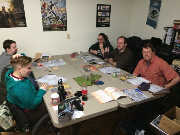 Counter clockwise, from lower left: Toby, Cory, Hunter, Jake and Tom sit around the game table.